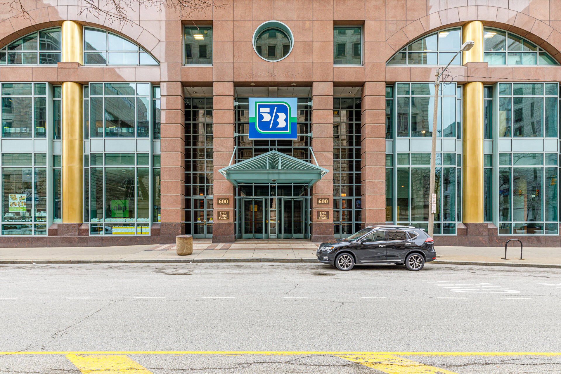 Commercial office building entrance with brick base and modern glass tower — Skoda Construction project, downtown Cleveland