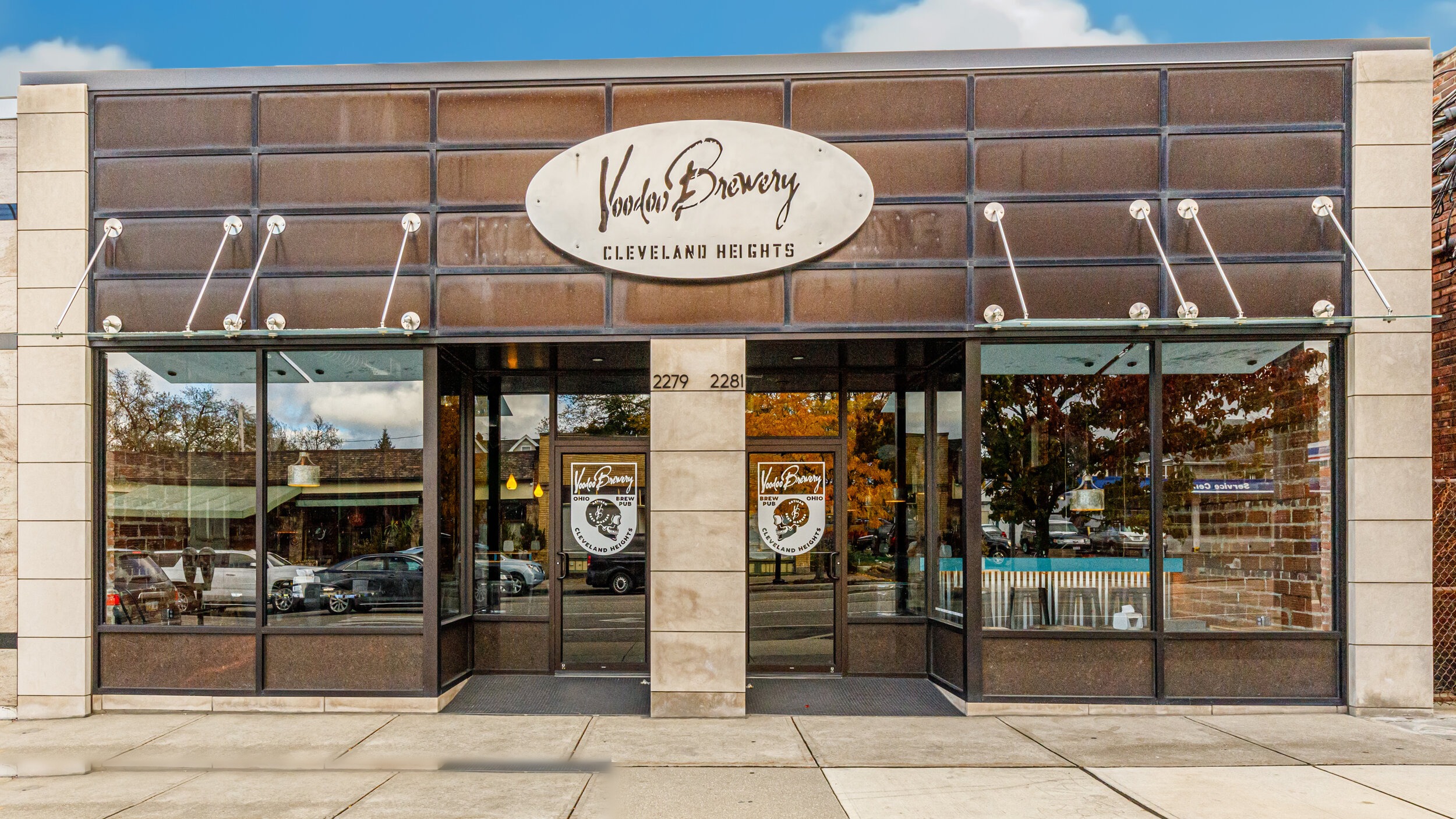VooDoo Brewery Cleveland Heights storefront with brown tile facade, oval signage, and glass entry doors — commercial build-out by Skoda Construction