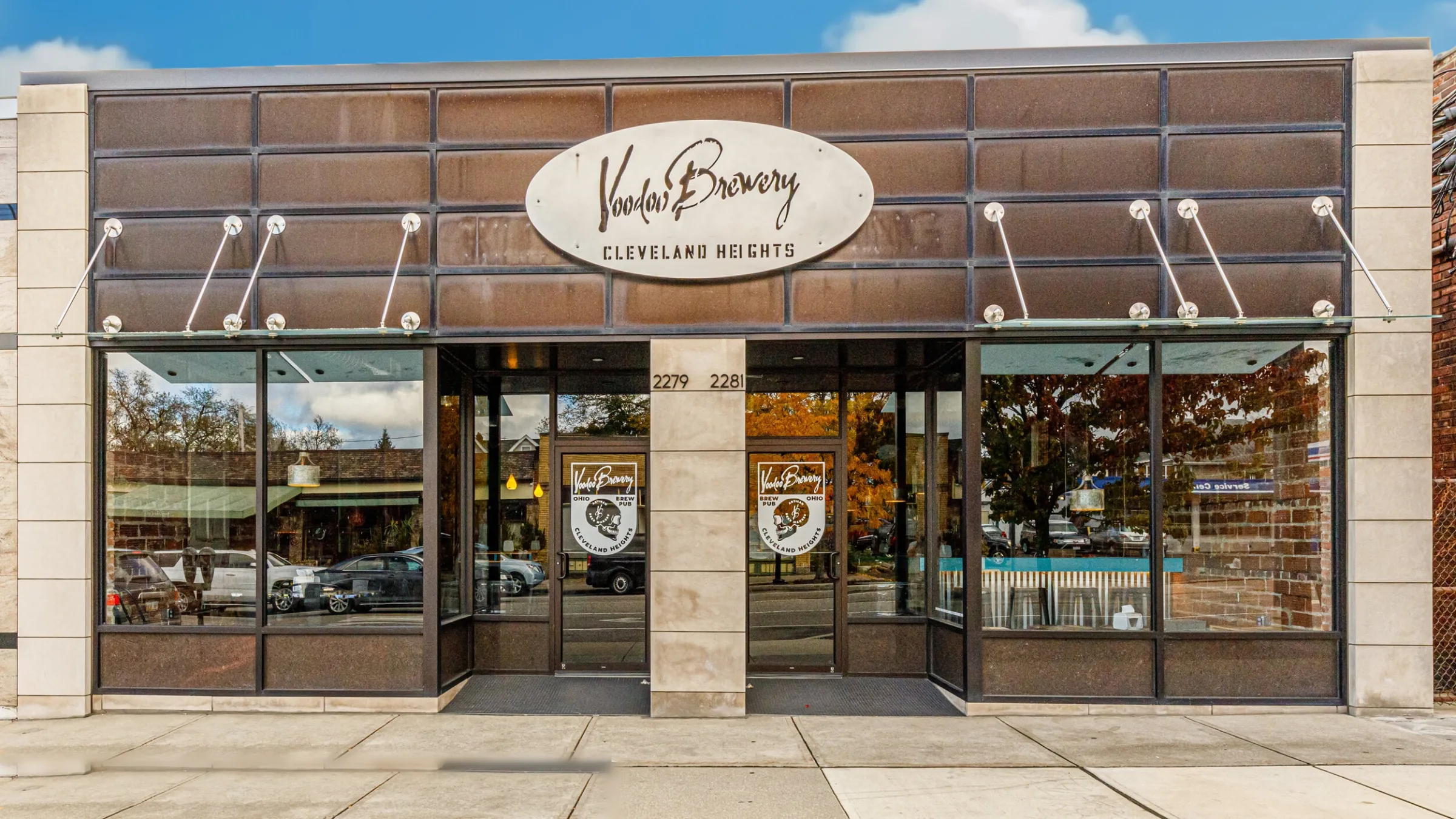 VooDoo Brewery Cleveland Heights storefront with brown tile facade, oval signage, and glass entry doors — commercial build-out by Skoda Construction