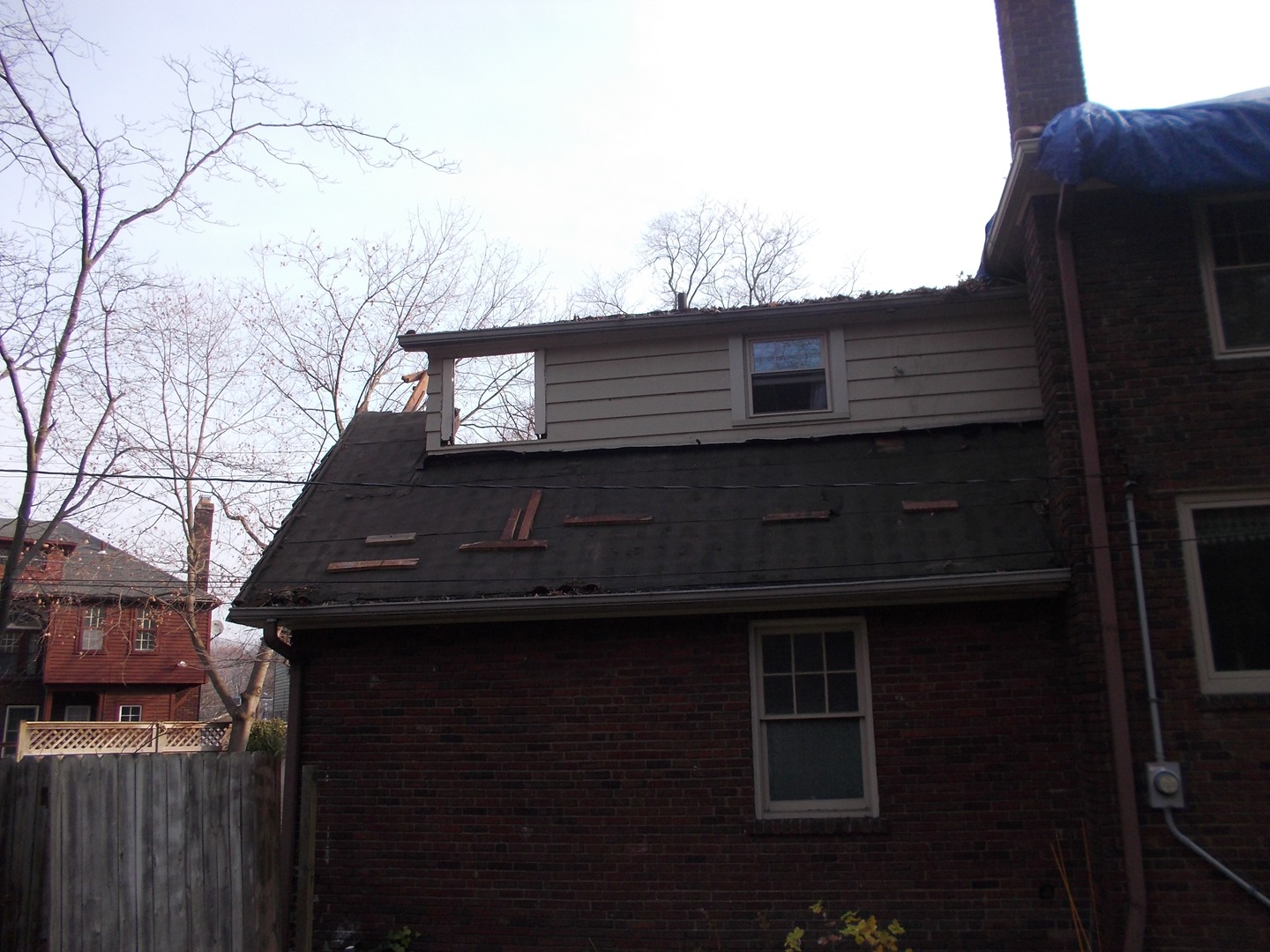 Roof Repair — Emergency roof repair in progress — protecting the home from further damage