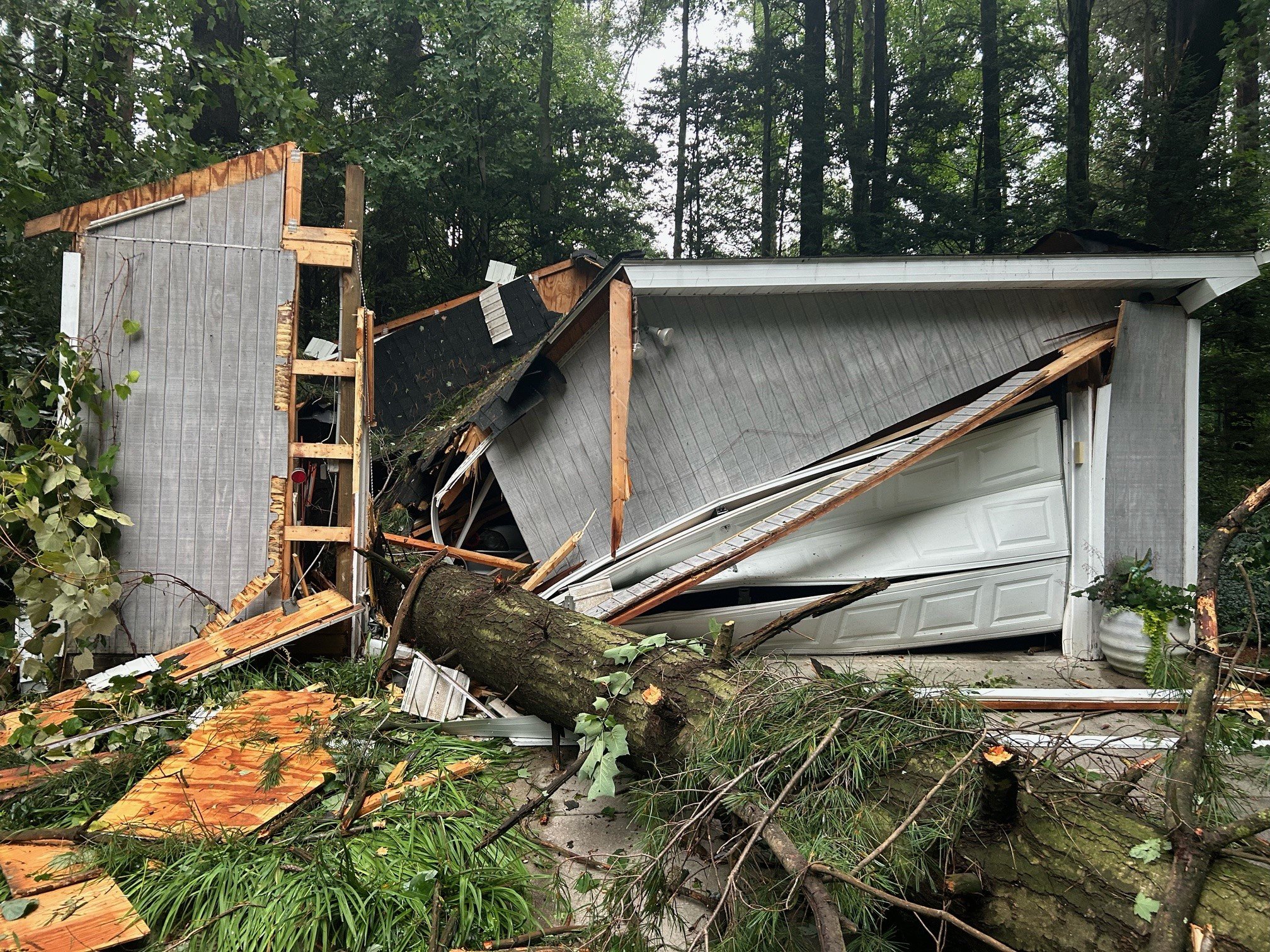 Storm Damage — Fallen tree destroyed garage — emergency response and rebuild